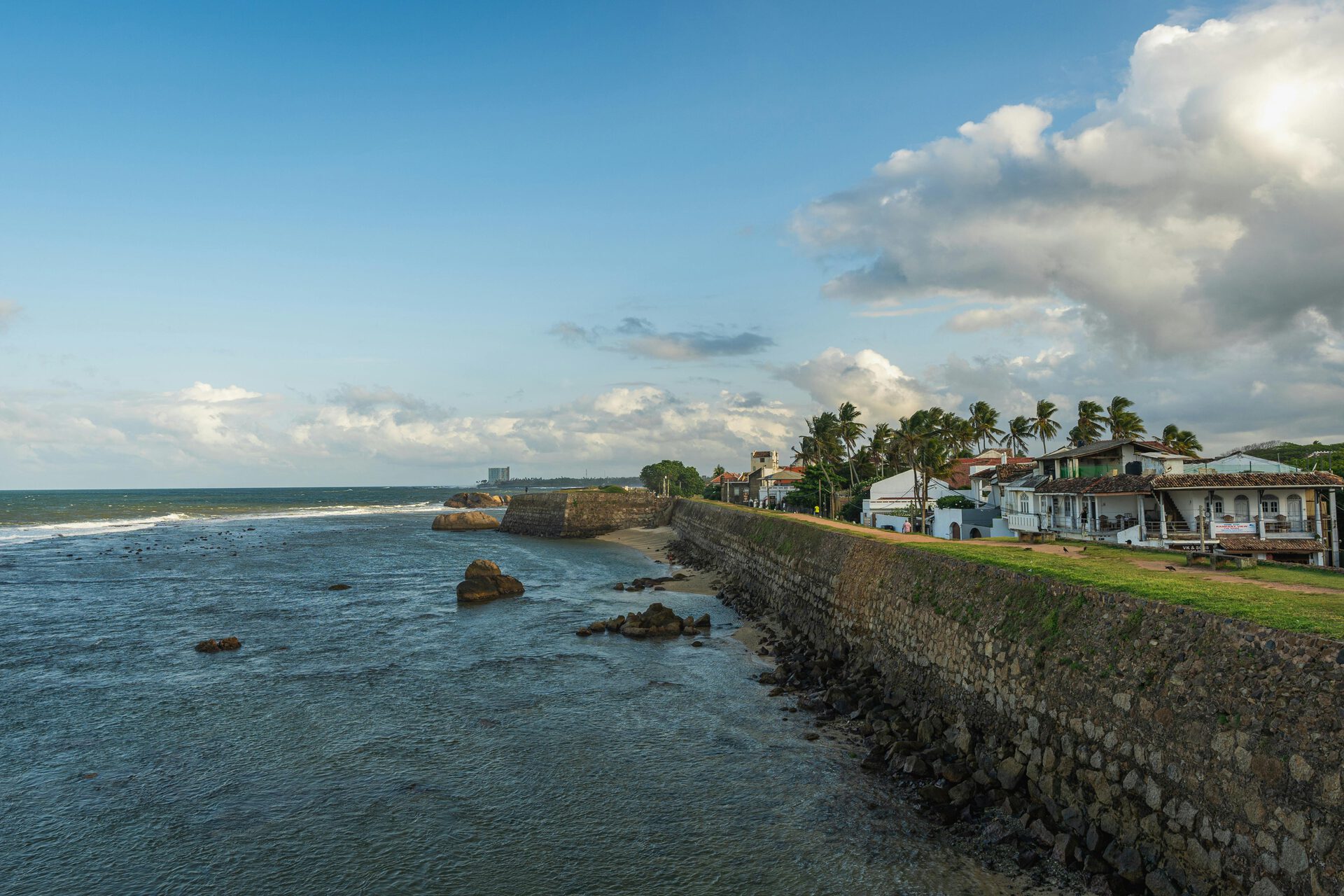 Galle Fort ramparts at sunset with the lighthouse and Indian Ocean beyond
